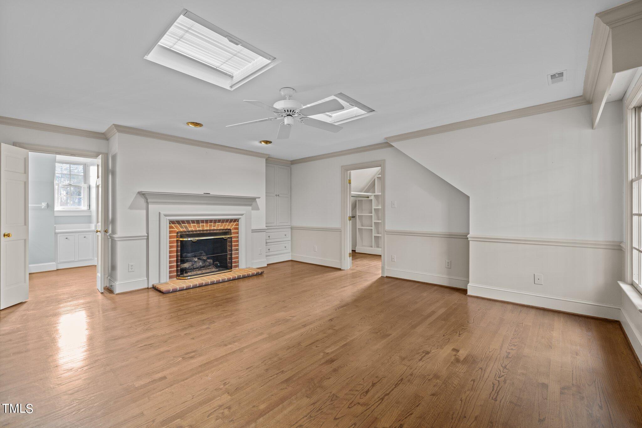 3608 Dover Road Durham, NC 27707 - Photo 37 of 58 an empty room with wooden floor fireplace and windows