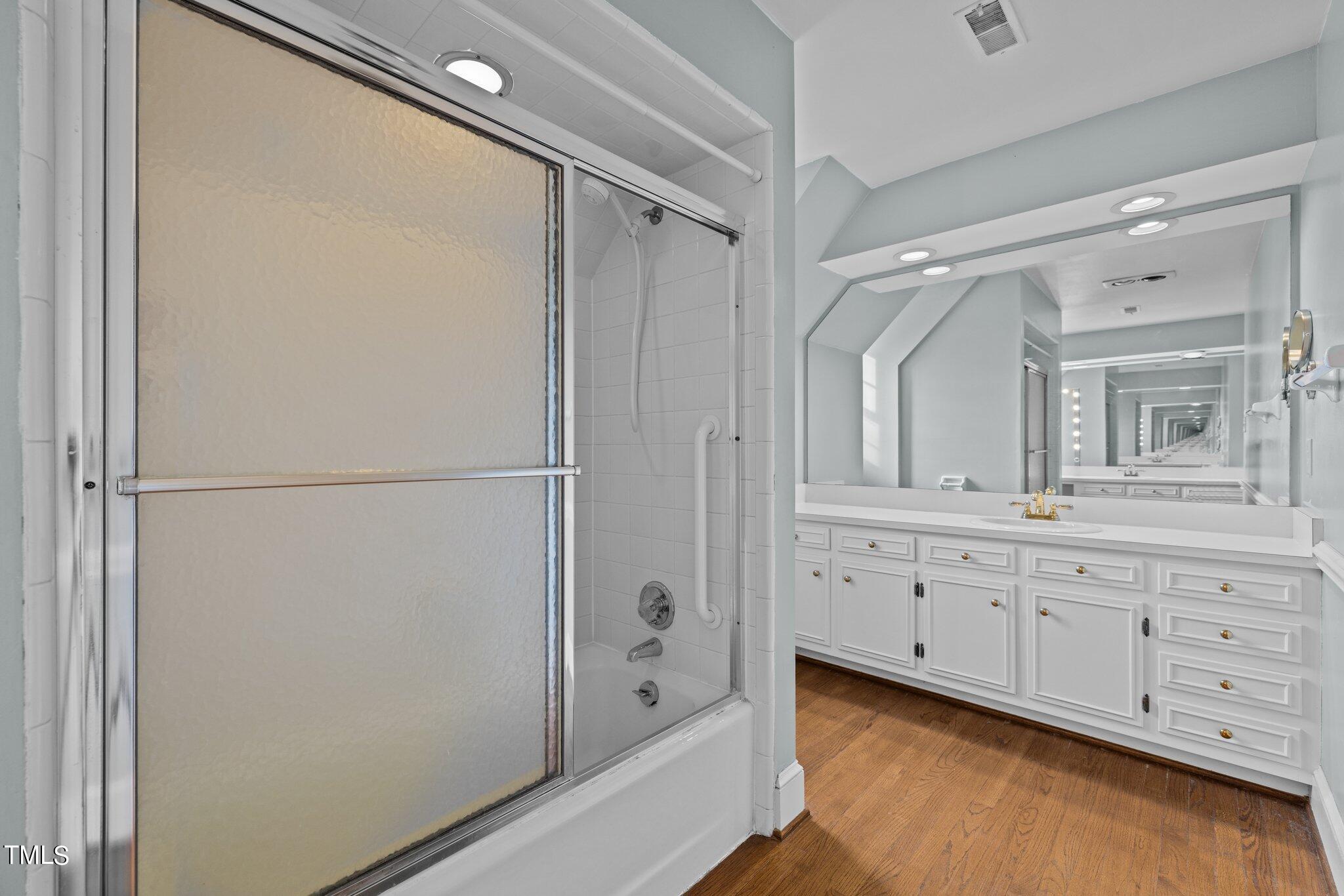3608 Dover Road Durham, NC 27707 - Photo 39 of 58 a bathroom with a double vanity sink and mirror