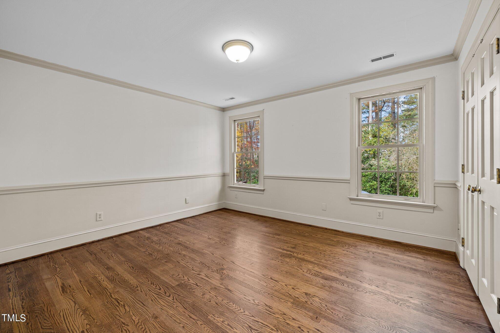 3608 Dover Road Durham, NC 27707 - Photo 41 of 58 an empty room with wooden floor and windows