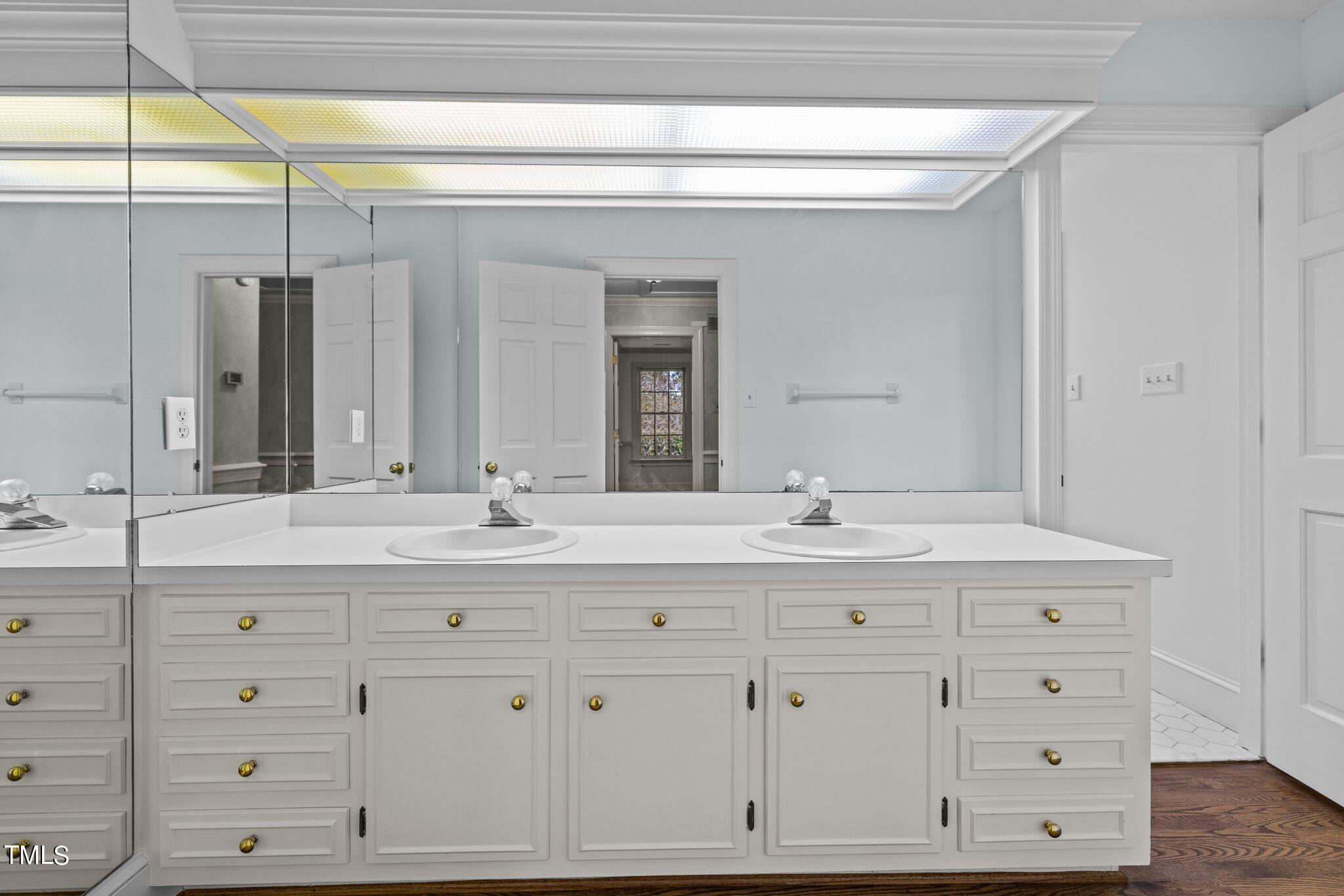 3608 Dover Road Durham, NC 27707 - Photo 42 of 58 a bathroom with a sink vanity and mirror