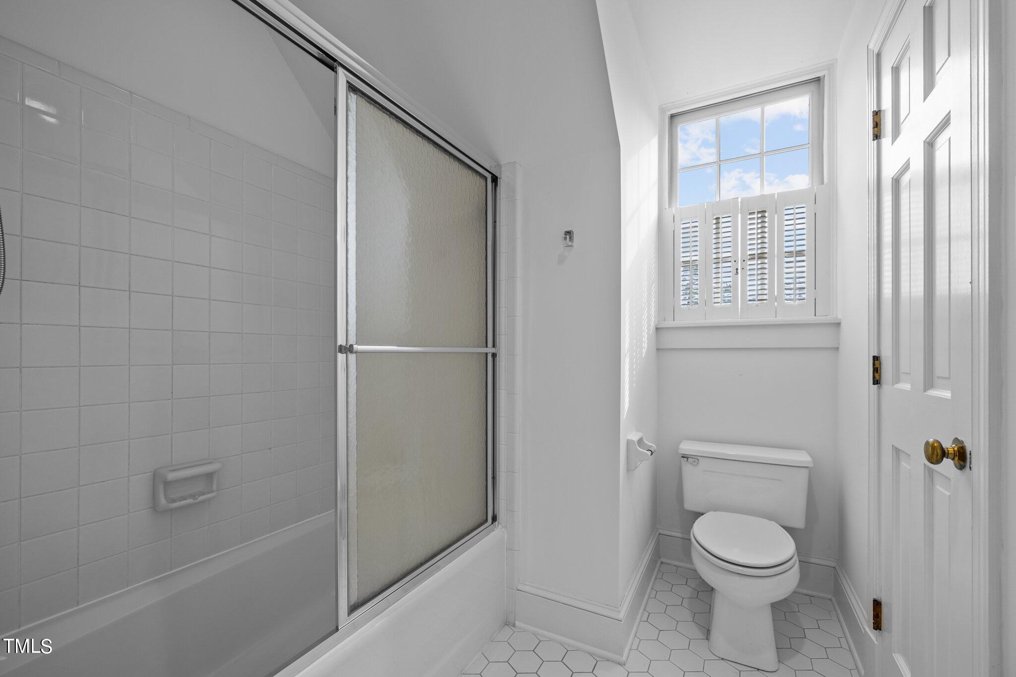 3608 Dover Road Durham, NC 27707 - Photo 43 of 58 a bathroom with a granite countertop toilet a sink and shower