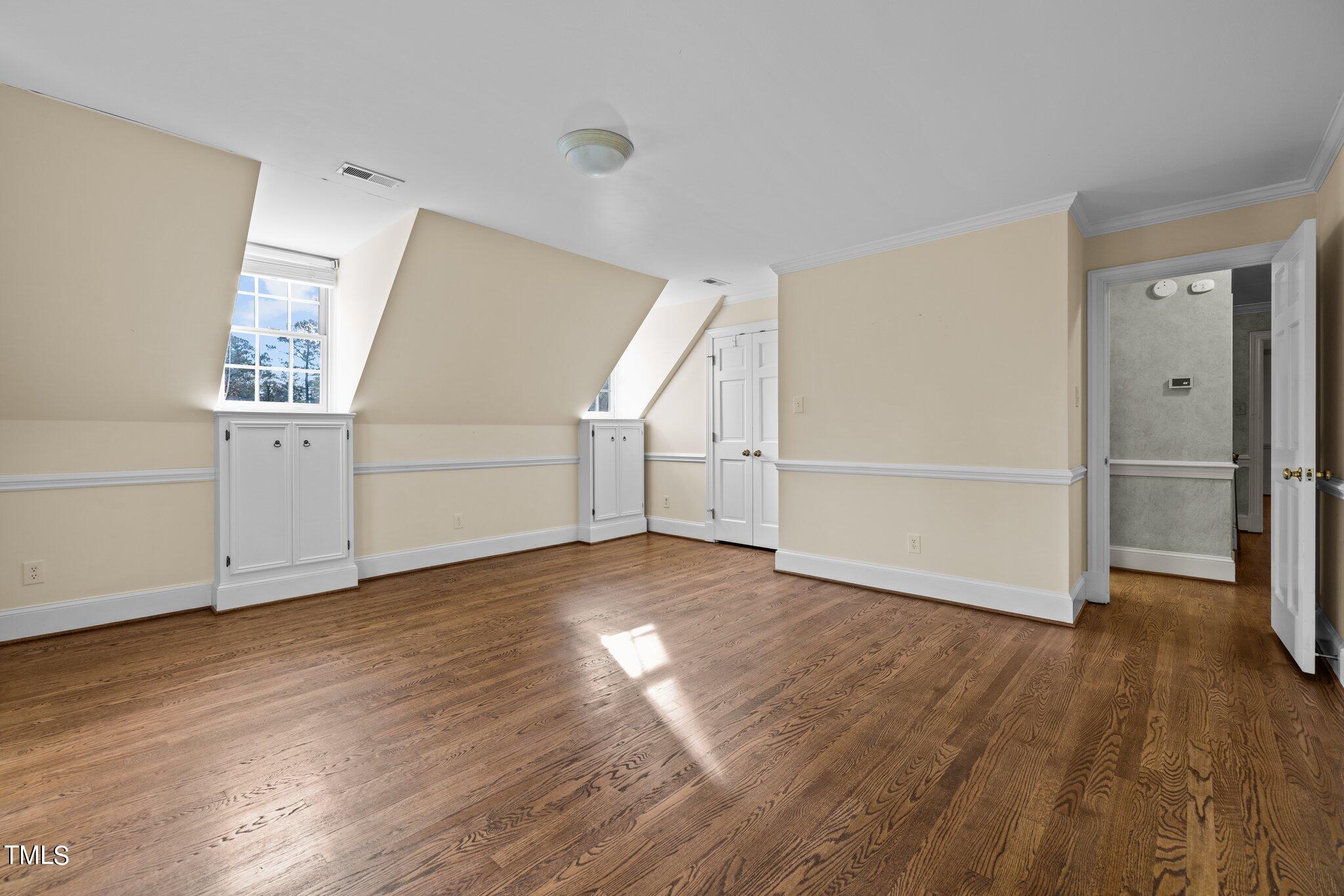 3608 Dover Road Durham, NC 27707 - Photo 44 of 58 an empty room with wooden floor closet and windows