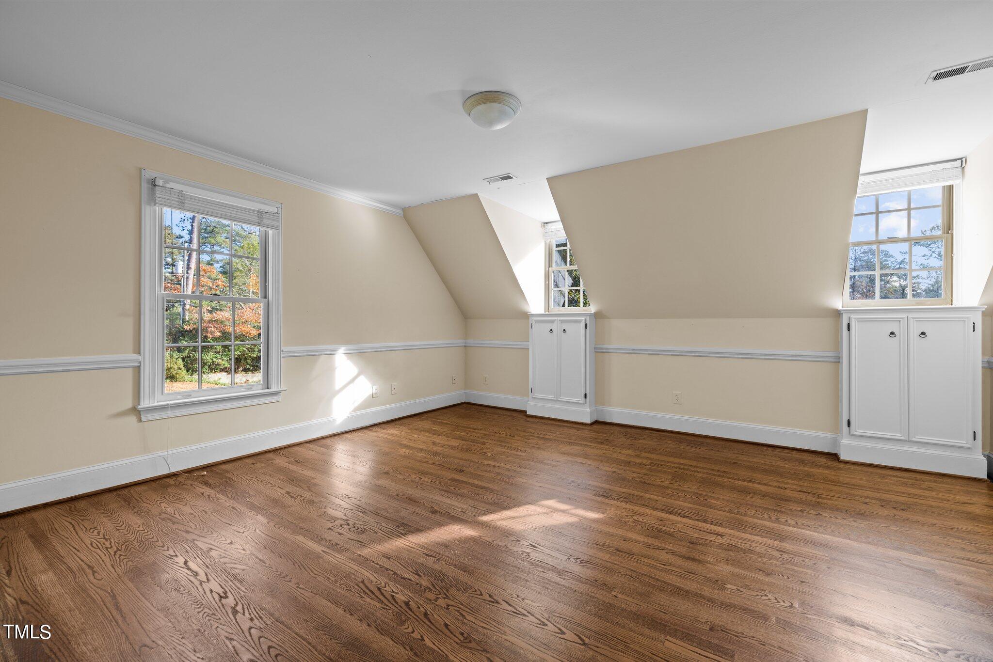 3608 Dover Road Durham, NC 27707 - Photo 45 of 58 an empty room with wooden floor and windows