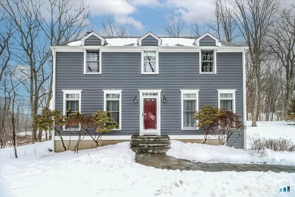 a front view of a house with outdoor seating