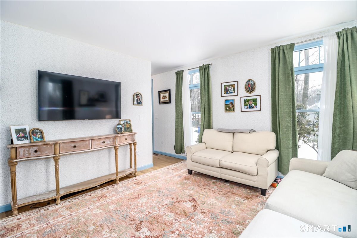52 Key Rock Road Newtown, CT 06470 - Photo 14 of 40 a living room with furniture and a flat screen tv