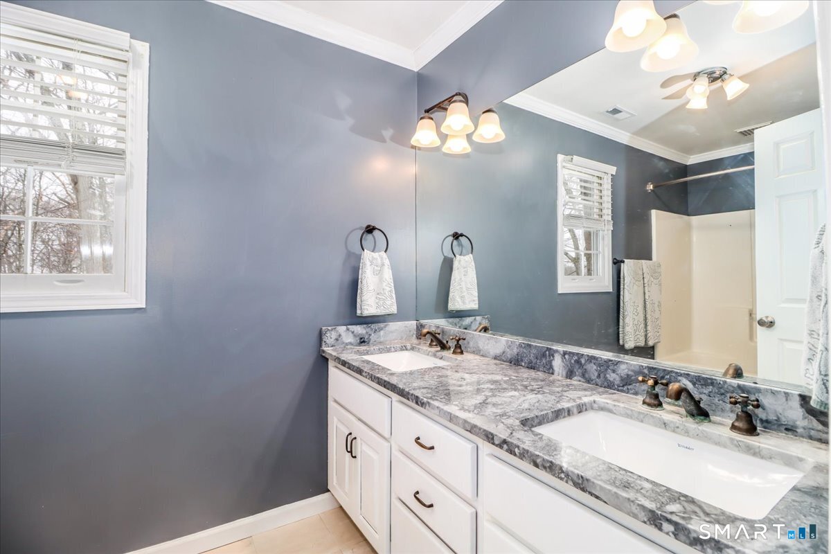 52 Key Rock Road Newtown, CT 06470 - Photo 22 of 40 a bathroom with a granite countertop sink a large mirror and a window