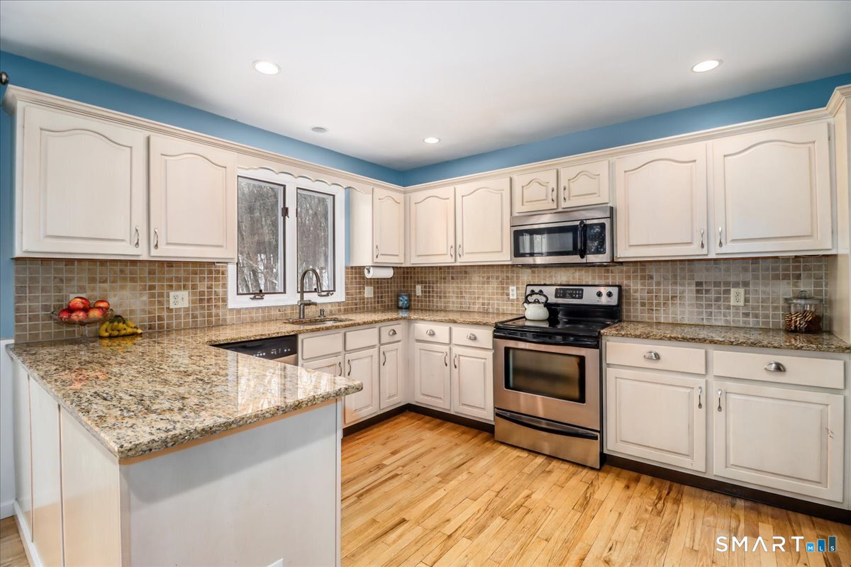 52 Key Rock Road Newtown, CT 06470 - Photo 3 of 40 a kitchen with kitchen island granite countertop a sink cabinets and stainless steel appliances