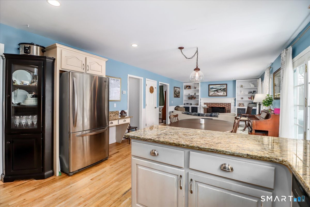52 Key Rock Road Newtown, CT 06470 - Photo 7 of 40 a kitchen with granite countertop a refrigerator and wooden floor
