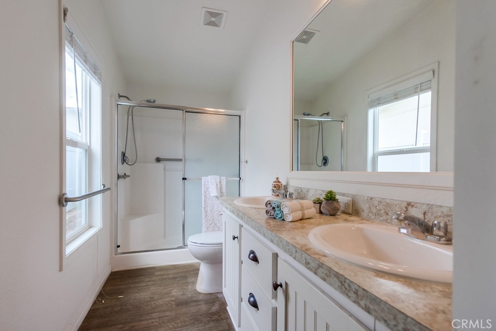 3909 Reche Road, Unit 185 Fallbrook, CA 92028 - Photo 13 of 22 a bathroom with a sink a toilet and a large mirror