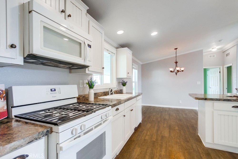3909 Reche Road, Unit 185 Fallbrook, CA 92028 - Photo 15 of 22 a kitchen with stainless steel appliances granite countertop a stove a sink and a microwave