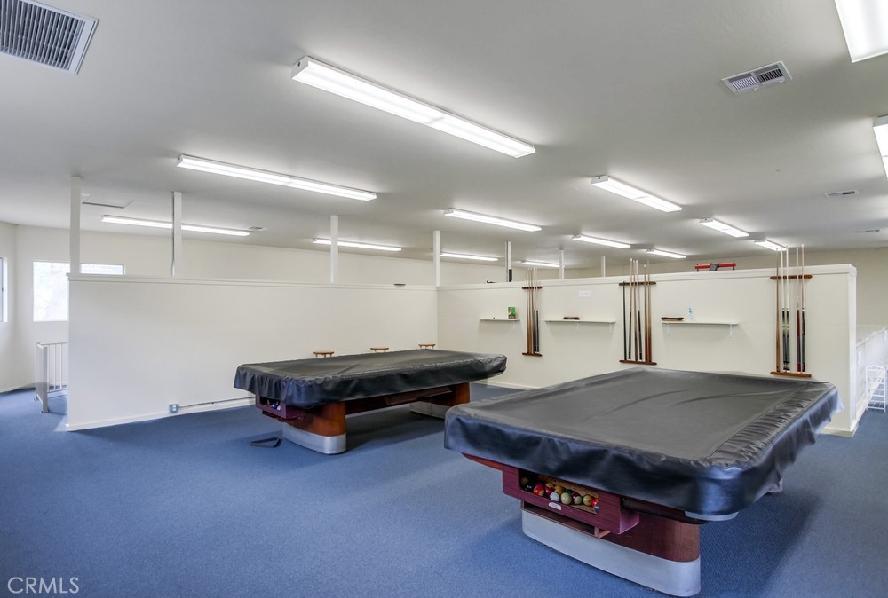 3909 Reche Road, Unit 185 Fallbrook, CA 92028 - Photo 5 of 22 a living room with kitchen furniture and a table