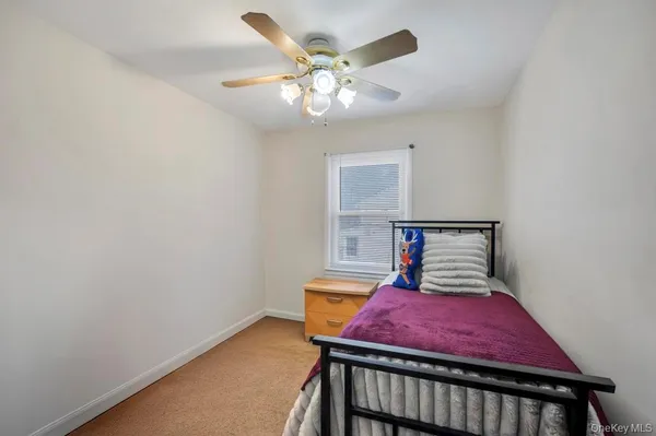 a bedroom with a bed and chandelier