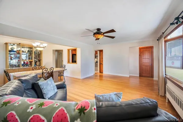 a living room with furniture and a floor to ceiling window