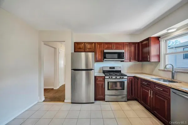a kitchen with stainless steel appliances granite countertop a refrigerator stove a sink and dishwasher