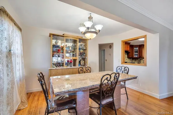 a view of a dining room with furniture wooden floor and chandelier