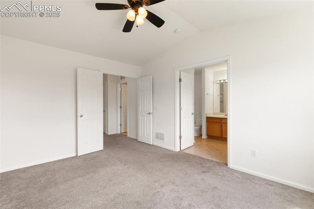 5679 Sunshade Point Colorado Springs, CO 80923 - Photo 13 of 30 a view of a livingroom with a ceiling fan and window