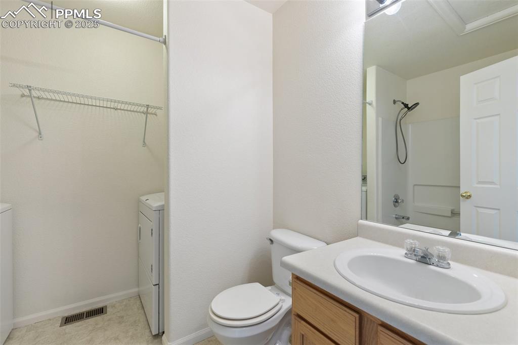 5679 Sunshade Point Colorado Springs, CO 80923 - Photo 16 of 30 a bathroom with a sink a toilet and shower