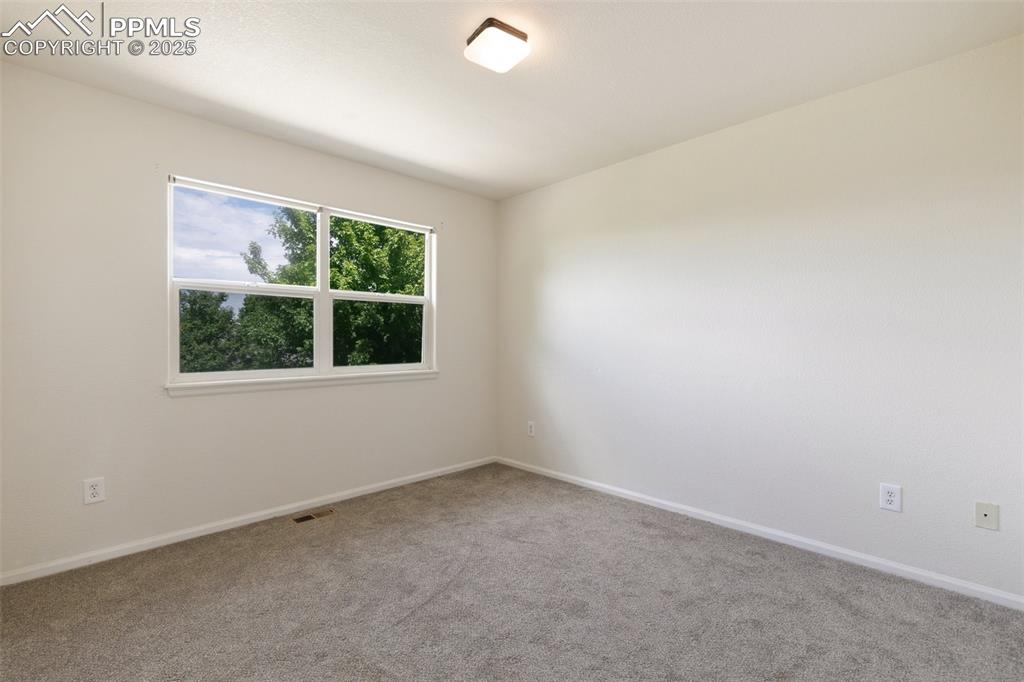 5679 Sunshade Point Colorado Springs, CO 80923 - Photo 17 of 30 an empty room with a window
