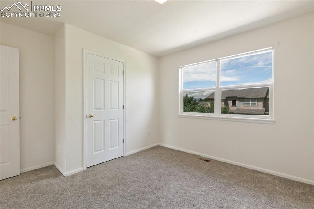 5679 Sunshade Point Colorado Springs, CO 80923 - Photo 18 of 30 a view of an empty room with a window