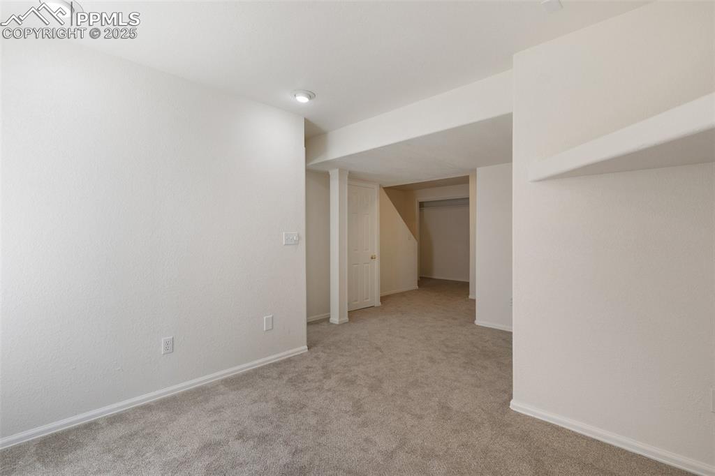5679 Sunshade Point Colorado Springs, CO 80923 - Photo 19 of 30 a view of an empty room and a window