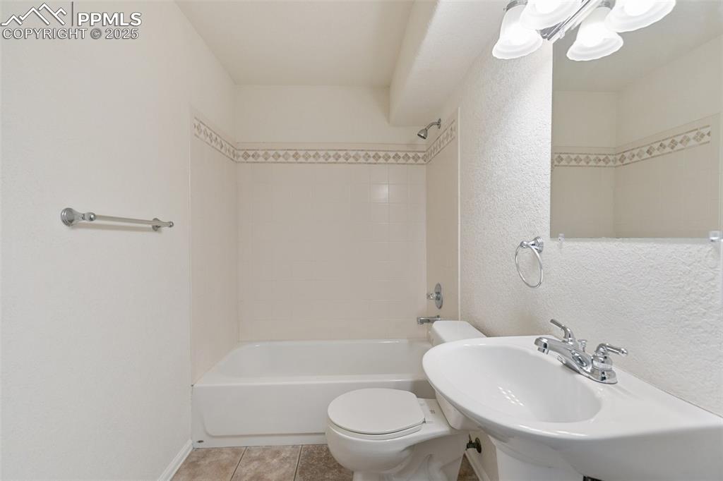5679 Sunshade Point Colorado Springs, CO 80923 - Photo 20 of 30 a bathroom with a sink a toilet and shower