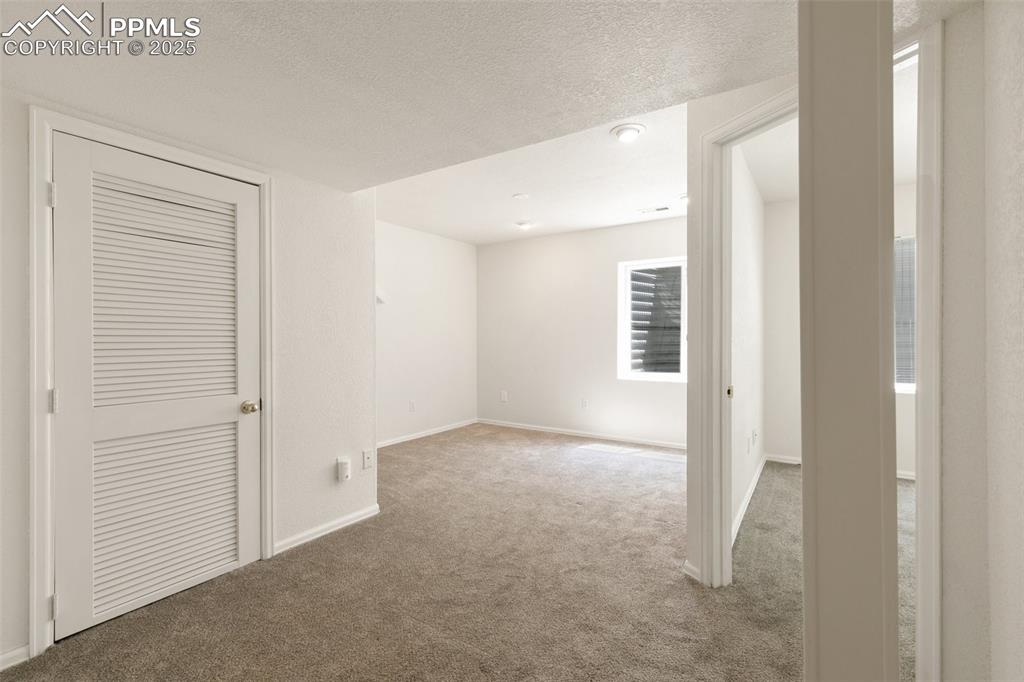 5679 Sunshade Point Colorado Springs, CO 80923 - Photo 22 of 30 an empty room with windows