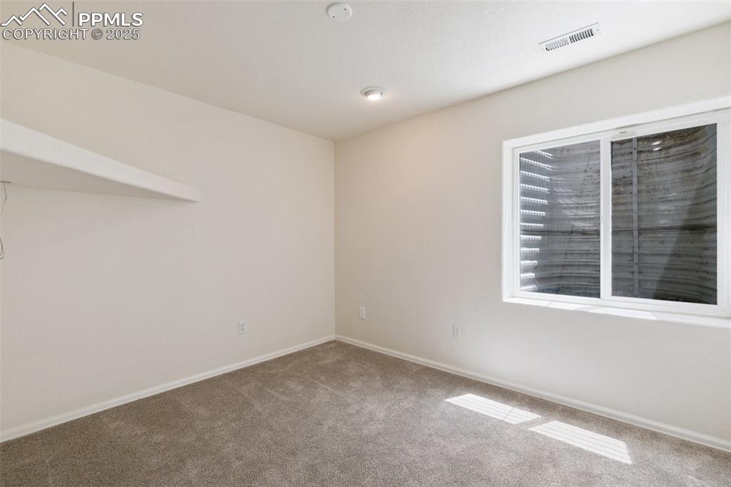5679 Sunshade Point Colorado Springs, CO 80923 - Photo 24 of 30 a view of an empty room with a window