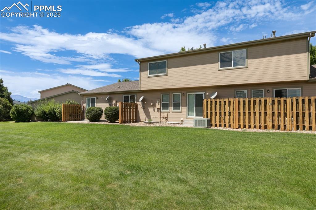 5679 Sunshade Point Colorado Springs, CO 80923 - Photo 25 of 30 a view of a house with backyard and porch