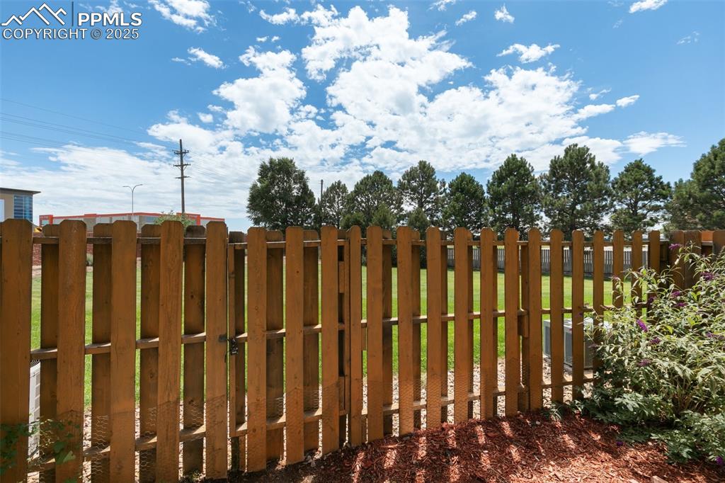 5679 Sunshade Point Colorado Springs, CO 80923 - Photo 27 of 30 a view of a row of white fence