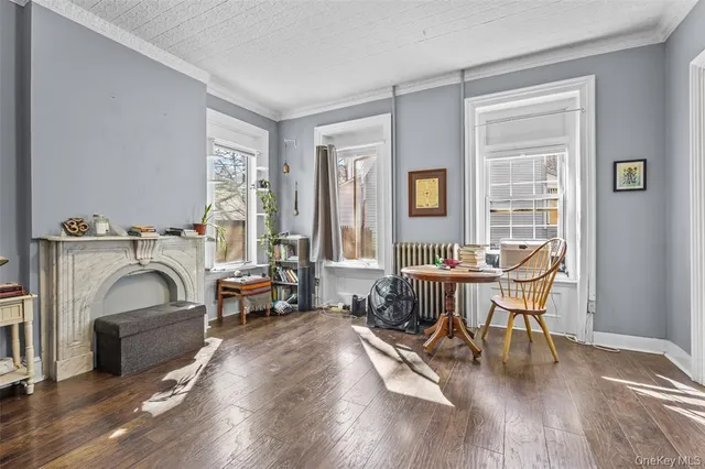a living room with furniture a fireplace and wooden floor