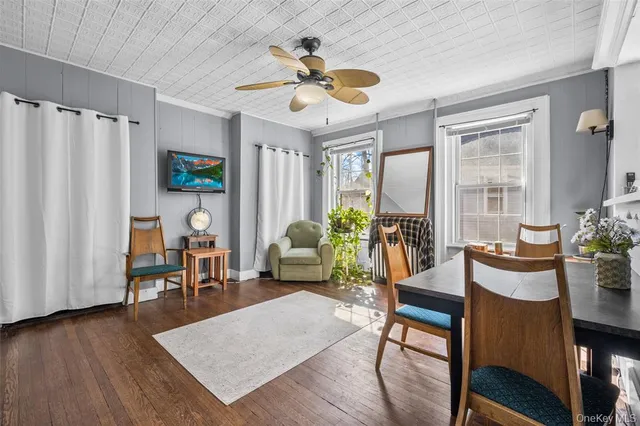 a living room with furniture a window and a potted plant