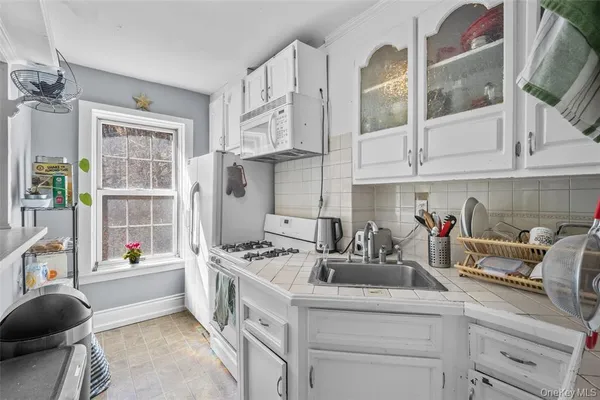 a kitchen with stainless steel appliances kitchen island granite countertop a sink and cabinets