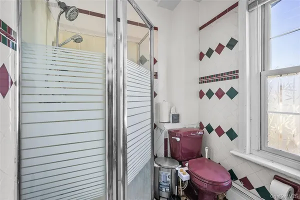 a bathroom with a toilet and a shower curtain
