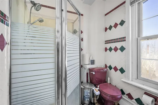 a bathroom with a toilet and a shower curtain