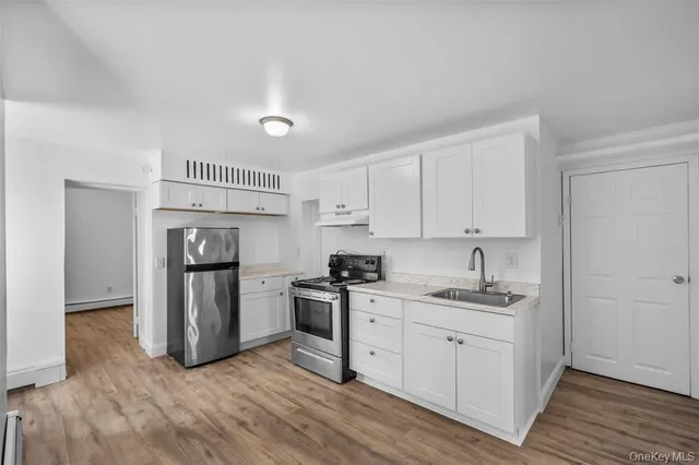 a kitchen with a sink cabinets and stainless steel appliances