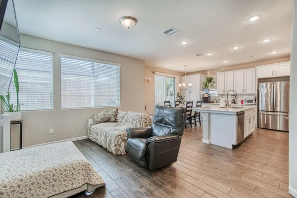 a living room with furniture and kitchen view