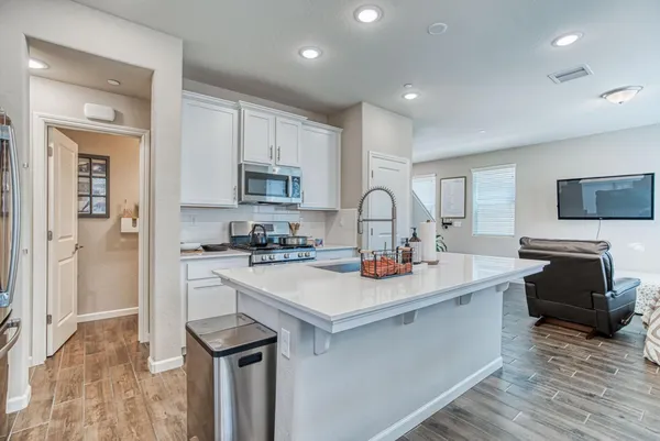 a kitchen with a sink a stove a refrigerator and a refrigerator