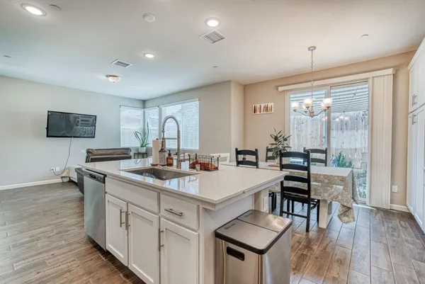 a open kitchen with stainless steel appliances granite countertop a sink stove and wooden floor