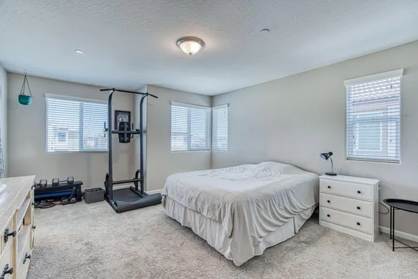 a bedroom with a bed and a window