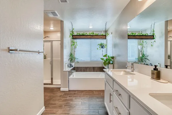a bathroom with a tub sink and mirror