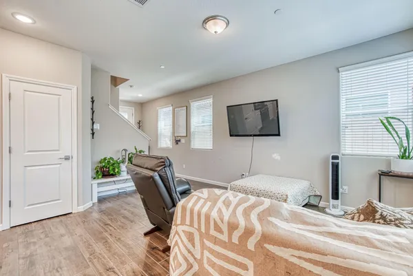 a bedroom with a bed tv and chair