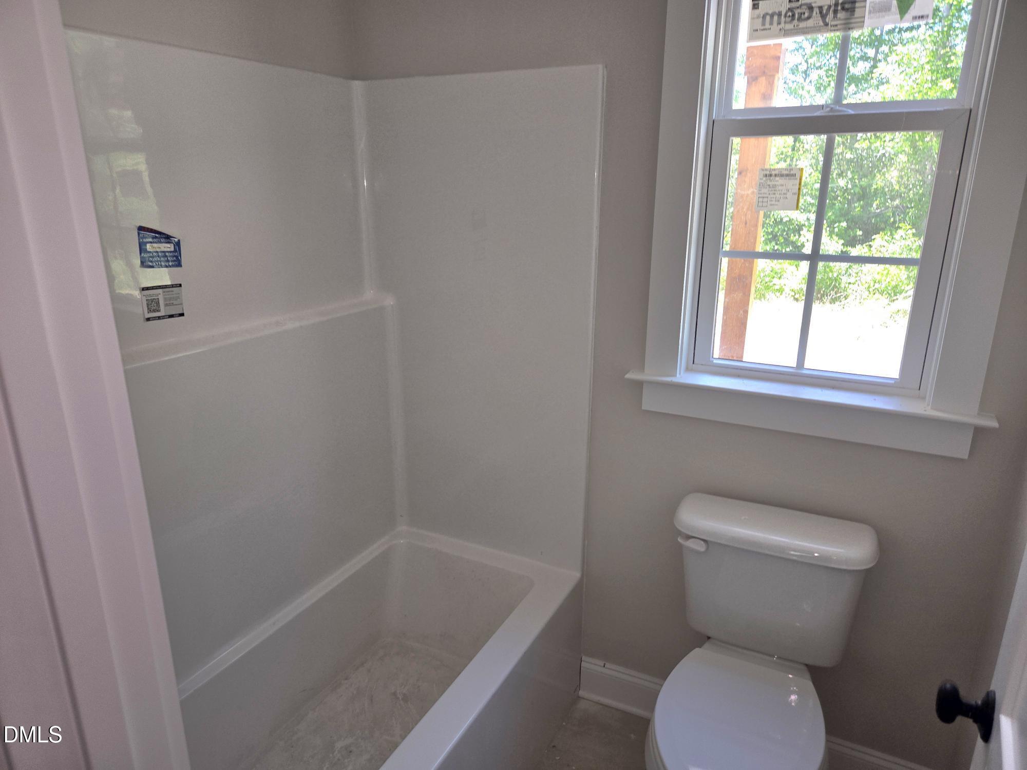 300 Avery Road Erwin, NC 28339 - Photo 15 of 38 a bathroom with a toilet and a shower