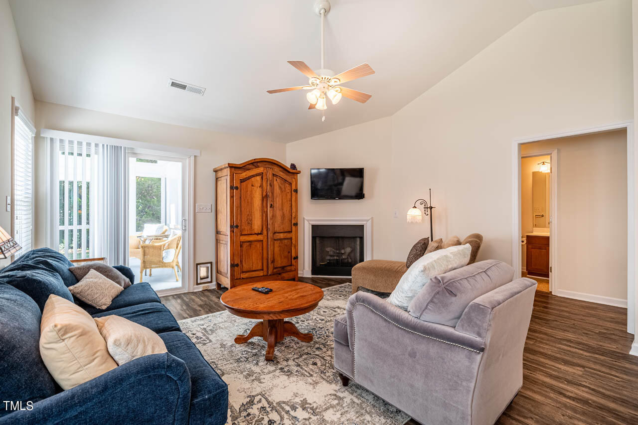 12 Pendleton Court Durham, NC 27713 - Photo 8 of 23 a living room with furniture a fireplace and a chandelier