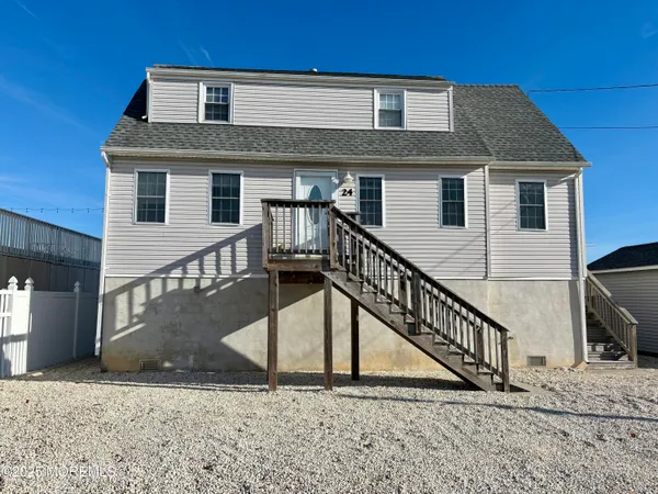 a front view of a house with wooden stairs