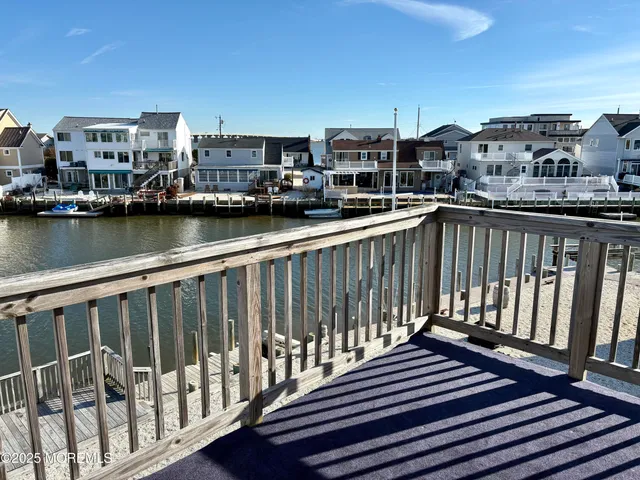a view of a balcony with wooden floor and city view