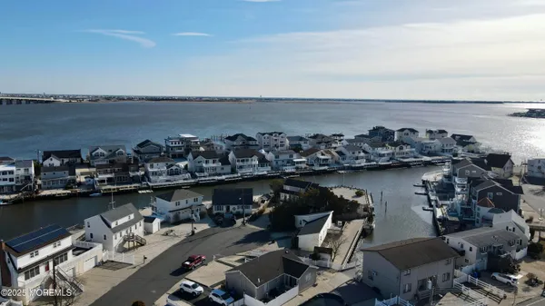 a view of a ocean with boats and trees in the background