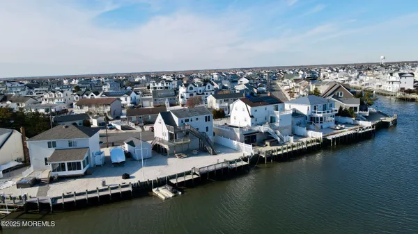 an aerial view of residential houses with ocean view