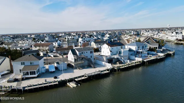 an aerial view of residential houses with ocean view