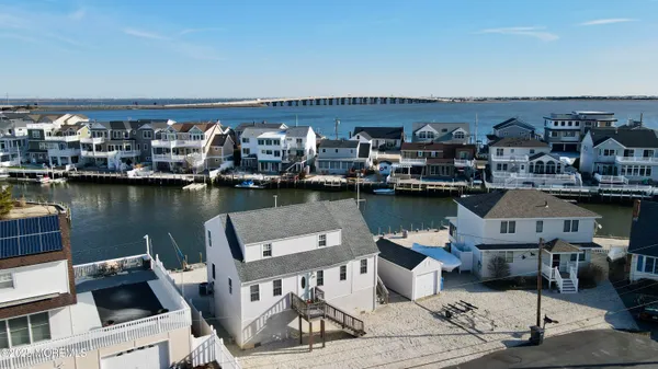 an aerial view of a house with swimming pool and outdoor seating