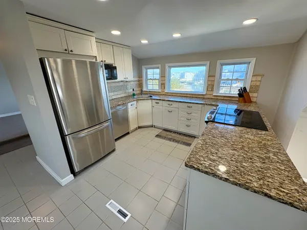 a kitchen with a refrigerator and a sink